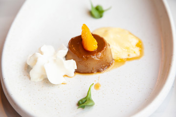 Coffee pudding served with whipped cream and passion fruit mousse