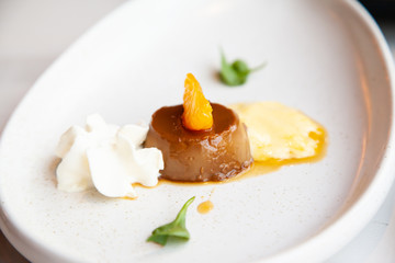 Coffee pudding served with whipped cream and passion fruit mousse