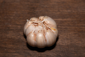 Close-up of garlic photos with a wooden board background.