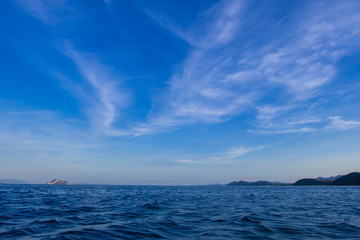 cirrus clouds over sea and blue sky in daylight