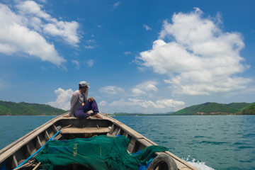 Fototapeta na wymiar A folk fisherman boat is running back to shore Koh Yao Yai Bay