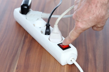 switching off a white plug socket - 329254858
