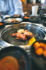 Korea bbq style restaurant  with meat and vegetable side diesh.