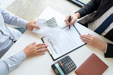 Businessman giving bribe money dollar banknotes in hands to partner in a corruption scam, Dishonest cheating in business illegal money Bribery and corruption concept.