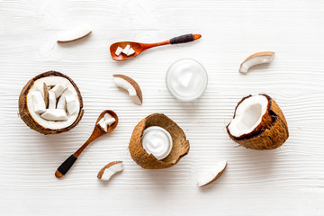 Homemade coconut cream - still life with spoon - on white wooden background top-down