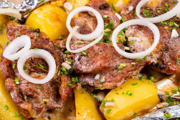baked in foil pork neck and potatoes with onion