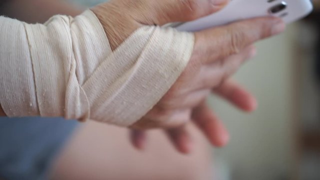 Trigger finger or Finger Lock Disease, Office syndrome technology concept. Businessman trying use smartphone while trigger digits or trigger thumb with pain, Myocardial pain syndrome nerve elbow