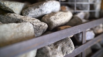 Close-up of natural gray rough stone for sauna. Can be used as a background. Stones in the sauna