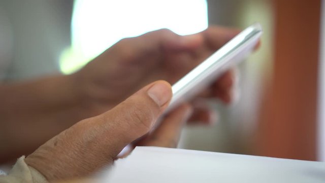 Trigger finger or Finger Lock Disease, Office syndrome technology concept. Businessman trying use smartphone while trigger digits or trigger thumb with pain, Myocardial pain syndrome nerve elbow