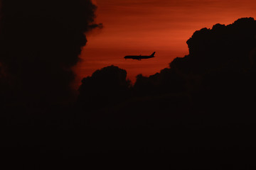 Silhouette of passenger airplane with the morning sunrise background