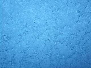 Fototapeta na wymiar Texture of snow-white snowflakes on the surface. Beautiful frosty snow pattern on the window. Winter Wallpaper with frosty snowflakes on the glass