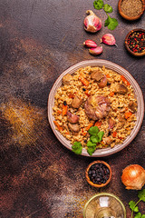 Pilaf with meat, vegetables and spices.