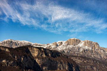 Peak of the Paganella or cima Roda (2125 m), snow caped Alps with the antennas of the weather station, seen from the Trento city, Adige Valley, Trentino Alto Adige, Italy, Europe