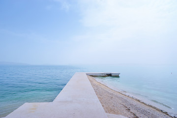 Concrete pier on the sea shore.