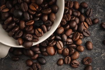 White coffee cup with coffee beans, fresh coffee, dark tone