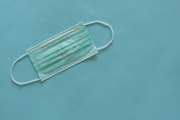 Surgical mask with elastic rubber straps.