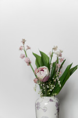 bouquet of flowers in glass vase isolated on white