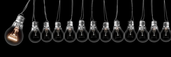 Dark and Shining Light Bulbs with Idea and Innovation Concept