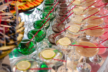 Different fresh alcoholic cocktail in glass on bar table, many colorful drinks. Party and holiday celebration concept