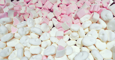 The background of the small candy Souffle pastel colors. Soft sweet Marshmallows scattered, top view.