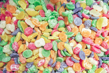 Flat top view of multicolored chewing marmalade. Texture of dessert marmalade with a sharp and sweet-sour taste. Jelly candies in bright red, yellow, green and orange colors.      