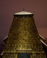 Wooden shingles and a weather vane atop an old wooden church. © Mikael