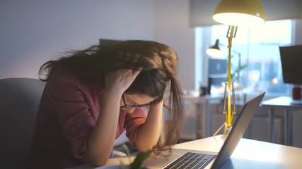 Worried business woman face looking at laptop in office. Close up of upset businesswoman thinking about mistakes in work. Portrait of sad girl looking laptop. Depressed employee working on laptop - Powered by Adobe