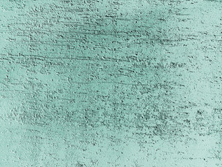 Decorative putty on the cracked wall surface. Painted into mint color. Decorative materials....