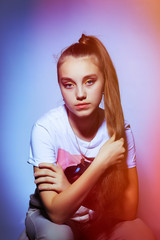 Teen girl in stylish clothes. Trend photos in 90s style. Toning photos with highlights.