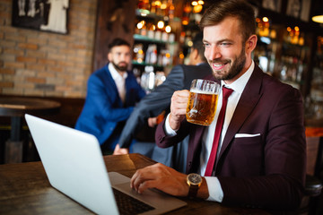 Handsome business man using laptop at his work break in restaurant