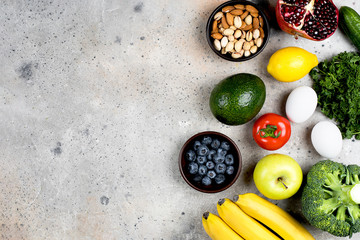 Food Nutrition Concept. Vegetables, fruits and bean product on light stone table background. Top view, flat lay, copy space