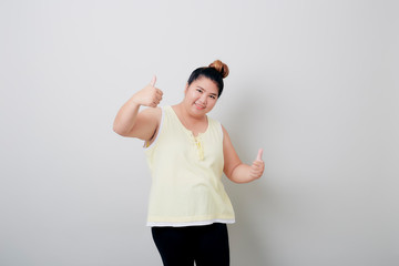 Young Asian woman giving thumbs up