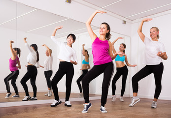 Fototapeta na wymiar Women dancing aerobics at lesson in the dance class