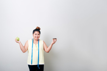 Fototapeta na wymiar Overweight woman eating food on gray background