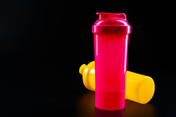 Sport bottle for drink on black background close up