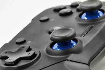 A part of gamepad on a white background. Game Joystick. Closeup, selective focus