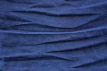 dark blue texture from a piece of old crumpled fabric on clothes