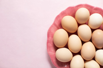  Plate with homemade fresh eggs on pink background