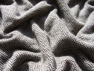 The texture of the fabric. Gray knit fabric with geometric patterns of wool and cotton.