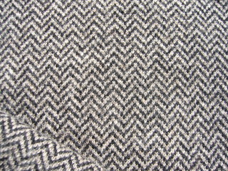 The texture of the fabric. Gray knit fabric with geometric patterns of wool and cotton.