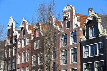 Close-up on colorful heritage buildings with gable rooftops, located along Brouwersgracht Canal in Amsterdam, Netherlands