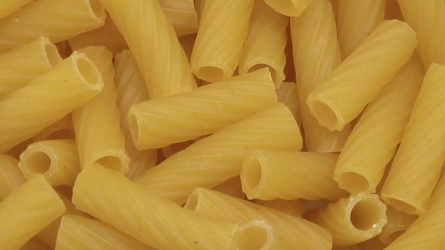 Pasta rigatoni rotates. Close up. The view from the top