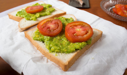 Avocado toast with fresh tomatoes slice, close up