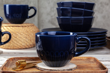 Still life photo of empty tea cup with honey spoon. Kitchen table close up