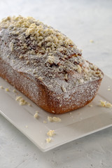 Tasty and fragrant cupcake with strawberries and almonds with a crispy crust on a white plate