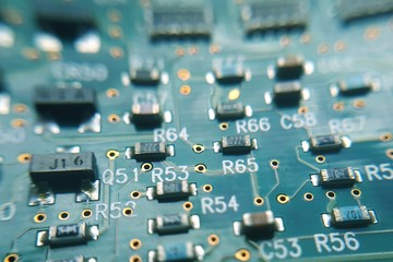 Closeup green computer PCB board. Macro picture of green printed circuit board - PCB.