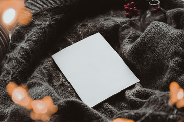 Winter autumn mock up with white book cover. Greetings card new year book mockup with red rowan berries over gray wool plaid. White book cover winter cozy mock-up.Warm festive rowan tree backdrop.