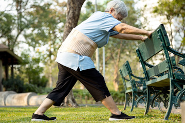 Happy asian senior woman exercising by stretching the leg muscles,female elderly has lost so much weight,excellent healthy,strong knee and bones,health care,body balance,good healthy lifestyle concept