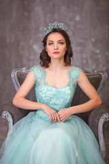  girl in a magnificent dress and with a crown on her head, queen