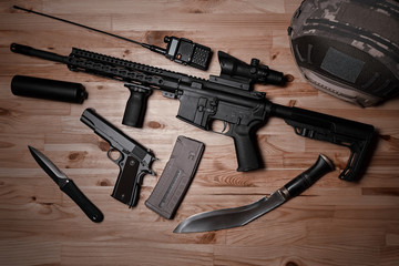 Weapons and military equipment for army, Assault rifle gun and pistol on wooden background.